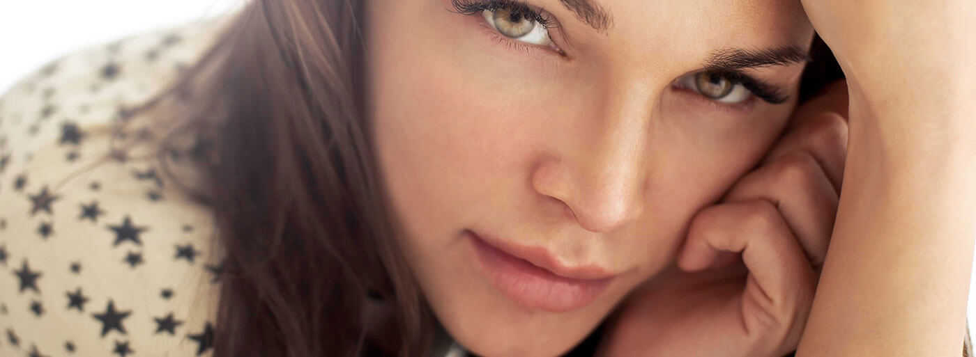 Woman leaning her face against her hand