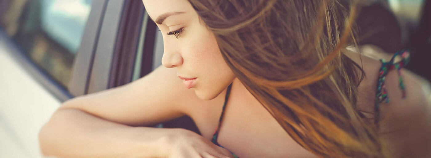 Woman leaning out of car window