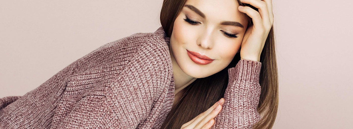 Woman wearing a sweater while looking down